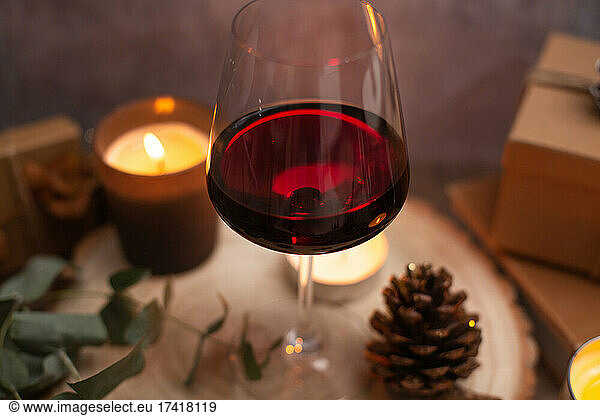 Christmas  wine glasses of mulled wine  lit candles and table decorations