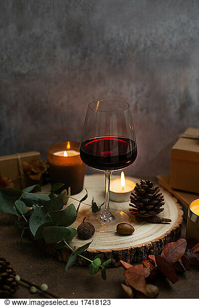Christmas  wine glasses of mulled wine  lit candles and table decorations