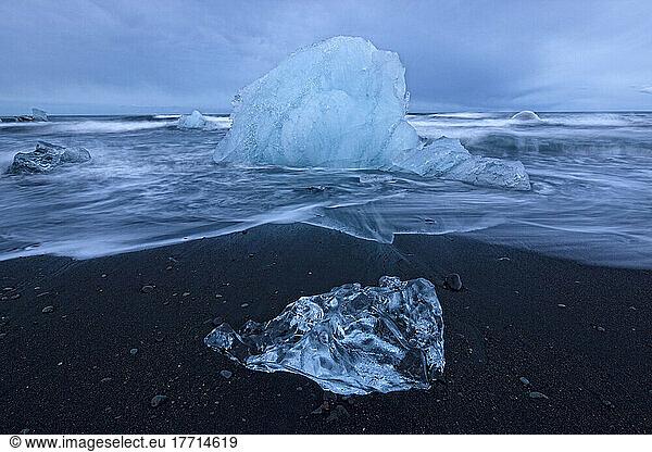 Chunks Of Ice Get Pounded By The Ocean Surf Near The Glacial Lagoon Jokulsarlon; Iceland