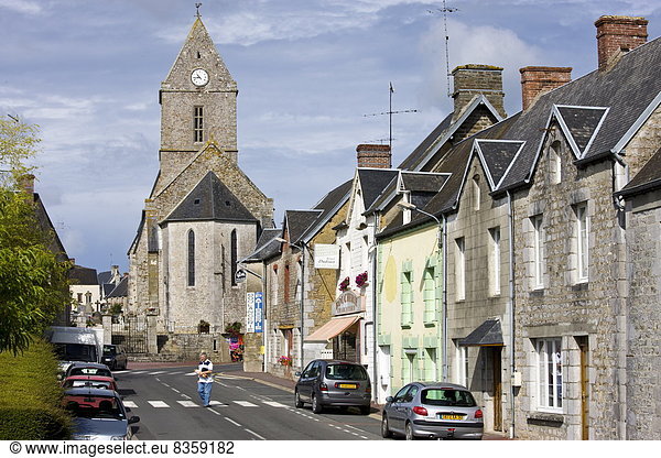 Church and street scene in French town of Trelly in Normandy  France