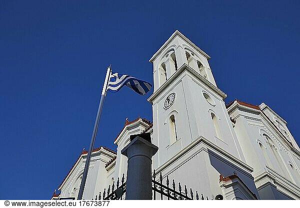 Church  steeple  wide angle shot  Greek national flag  blue cloudless sky  Chora  Andros Town  Andros Island  Cyclades  Greece  Europe