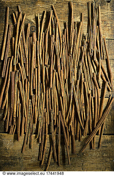 Cinnamon sticks lying on wooden surface