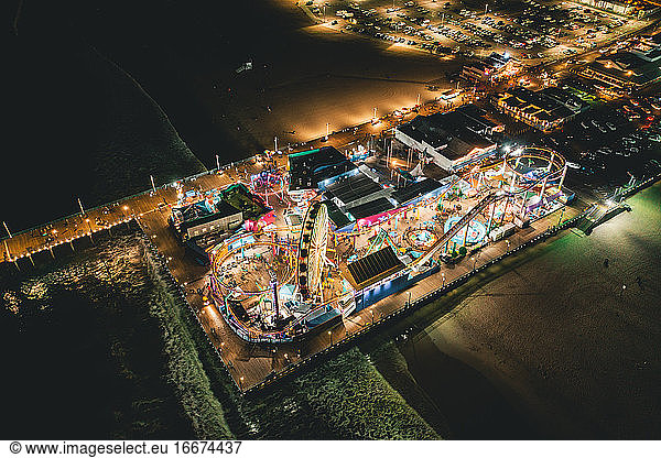 Circa November 2019: Santa Monica Pier at Night in super colourful lights from Aerial Drone perspective in Los Angeles  California