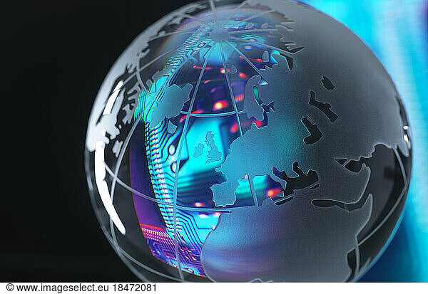 Circuit board reflecting in shiny globe