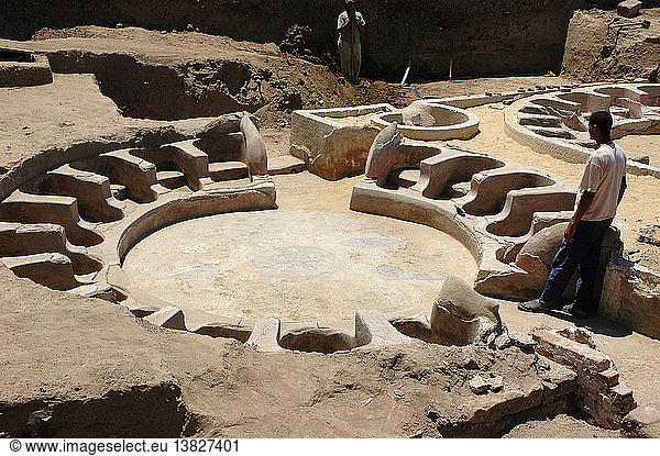 Circular baths outside the northwest perimeter wall of the Precinct of Amun,  Each bath seated 16 bathers,  with some seats flanked by dolphin statuettes. Egypt. Ancient Egyptian. Ptolemaic period. Karnak.
