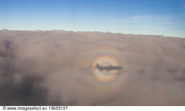 Circular rainbow with airplane shadow