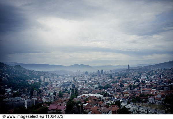 Cityscape against cloudy sky