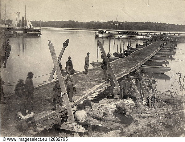 CIVIL WAR: PONTOON BRIDGE. U.S. Military Railroad Construction Corps working on a pontoon bridge on the wharf at Belle Plain Landing  on Potomac Creek  Virginia  to be used by General Ulysses S. Grant's army. Photographed by Andrew J. Russell  16 May 1864.
