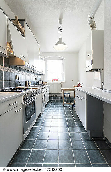 Clean apartment kitchen with tiled floor