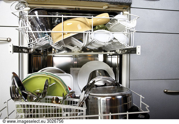 Cleaned dishes in open dishwasher  close-up