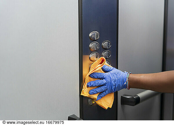 Cleaning professional thoroughly disinfecting elevator push butt