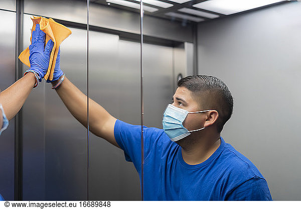 cleaning professional thoroughly disinfecting the elevator