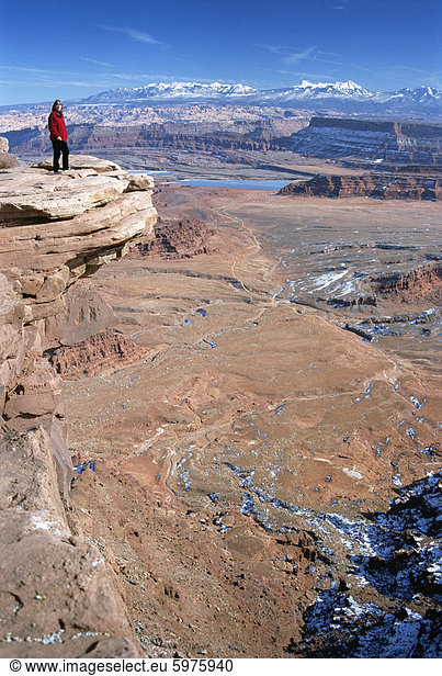 Cliff edge 300 m über dem roten Wüste Becken  mit Winterschnee auf La Sal Mountains hinaus  der Dead Horse Point State Park  Utah  Vereinigte Staaten von Amerika (U.S.A.)  Nordamerika