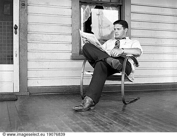Clifford Shorts reading evening paper  Aliquippa  Pennsylvania  USA  Arthur Rothstein  U.S. Farm Security Administration  July 1938