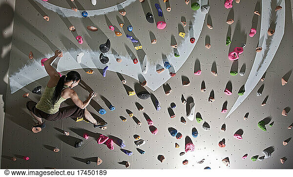 climber bouldering at indoor climbing wall in London