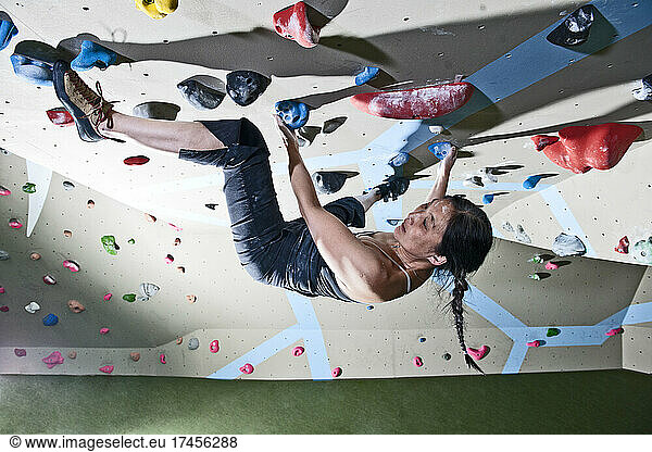 climber bouldering at indoor climbing wall in London