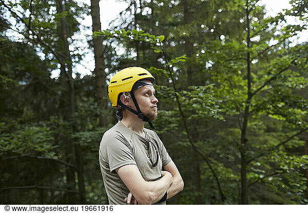 climber in a helmet looks up