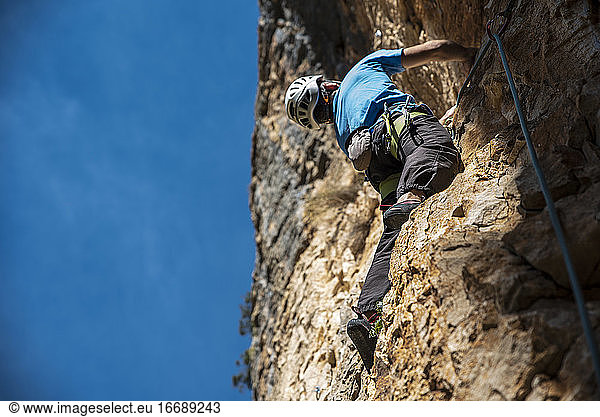 Climber in the right side and the blue sky in the left