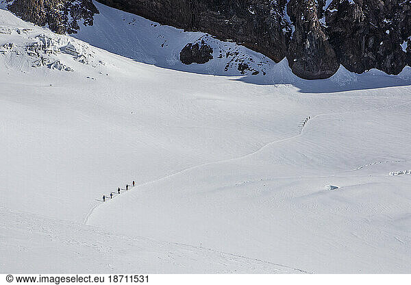 Climbers Descend a Trail Above Camp Muir on Mount Rainier  Washington