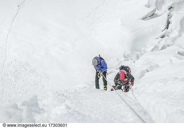Climbers navigating a glacier in Nepal