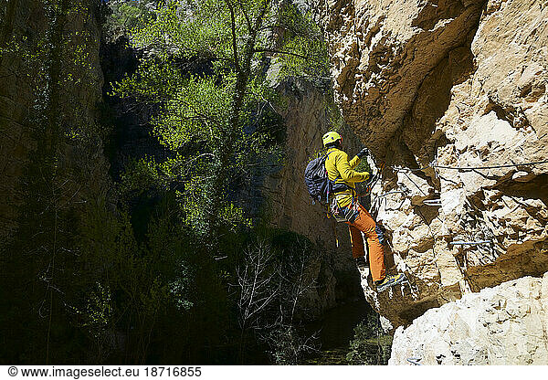 Climbing a ferrata route in San Blas  Arquillo reservoir in Teruel.