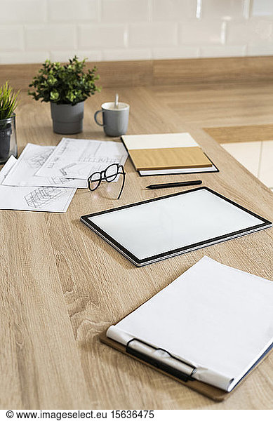 Clipboard  tablet and plan on wooden kitchen counter