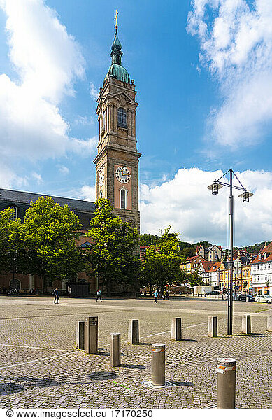 Clock tower of St George's Church against cloudy sky in Market Square at Eisenach  Germany