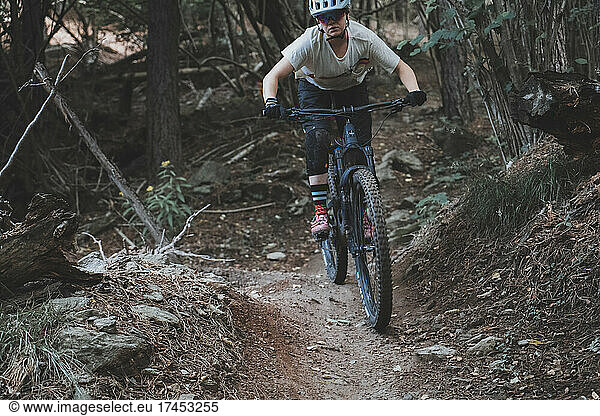 Close action shot of young woman riding a Mountainbike in forest