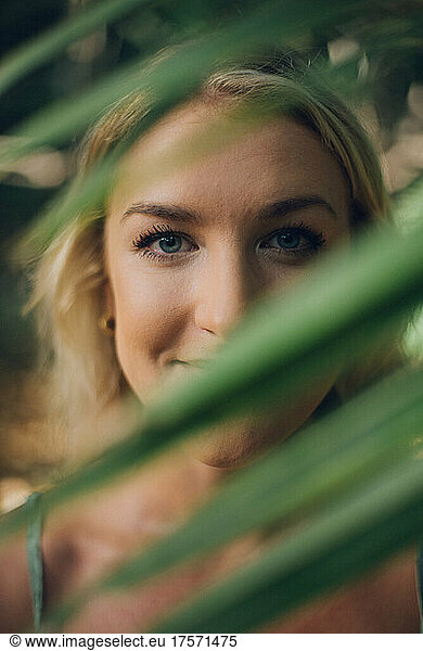 close portrait of a beauty blond girl in the jungle