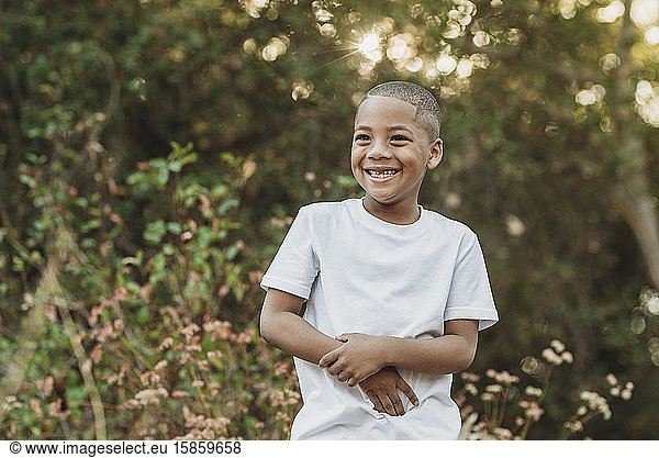 Close uo portrait of young school-aged confident boy smiling outside