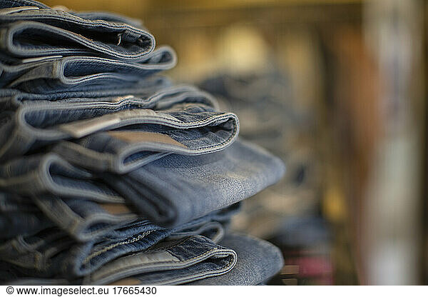 Close up denim jeans stacked in shop
