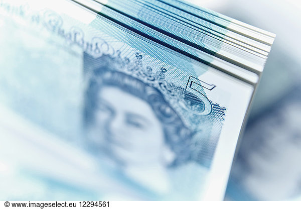 Close up five pound note stack