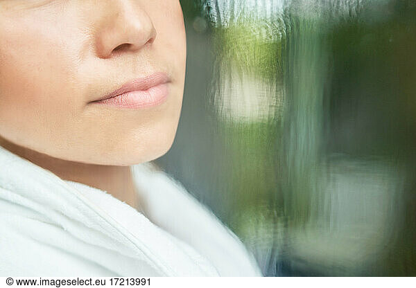 Close up lips of woman at window