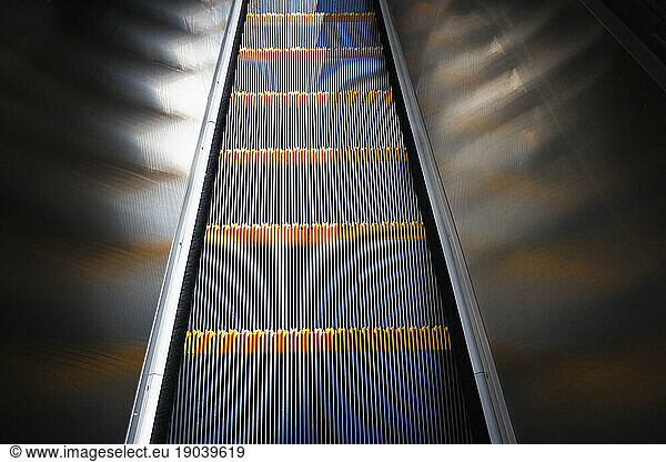 Close up  looking down moving escalator.