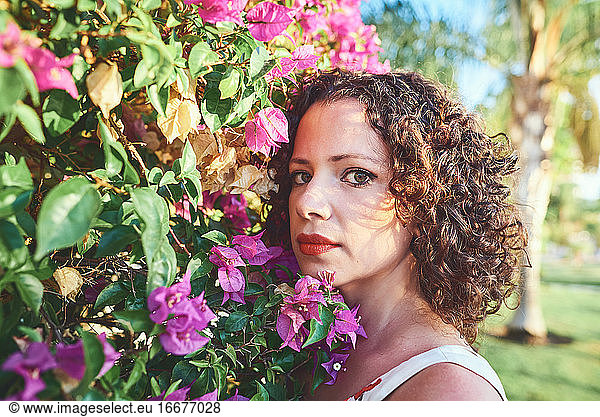 Close-up of a beautiful woman among the vegetation of a park.