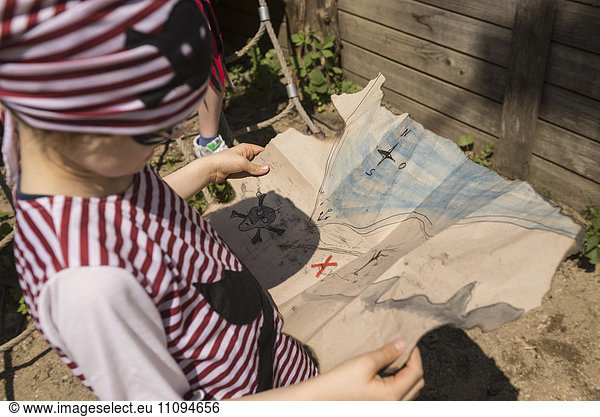 Close-up of a boy examining a treasure map in a adventure playground  Bavaria  Germany