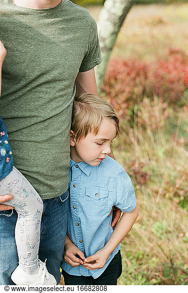 Close up of a five year old boy in his fathers arms