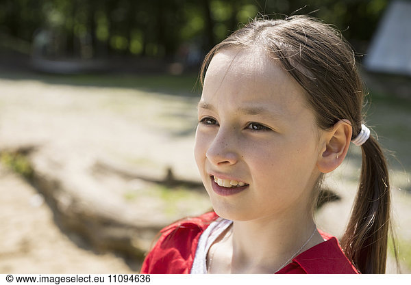 Close-up of a girl smiling in playground  Bavaria  Germany