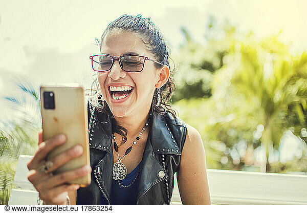 Close up of a happy girl checking her cell phone