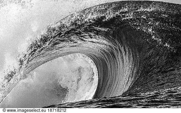 Close up of a huge and powerful wave breaking  Tahiti black and white