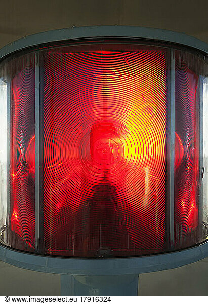 Close up of a lantern and lightbulb  radiating heat and light  red and yellow.