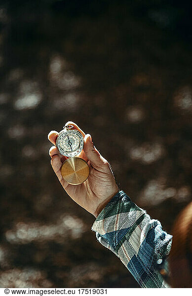 Close-up of a man's hands holding a compass