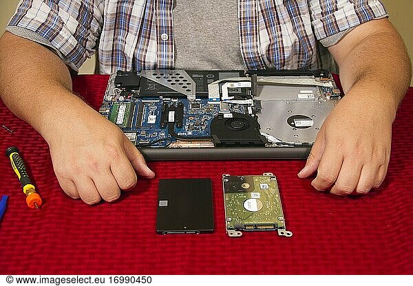 Close-up of a man working on a laptop computer.