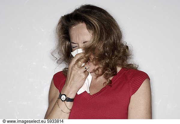 Close-up of a mature woman sneezing. Close-up of a mature woman sneezing