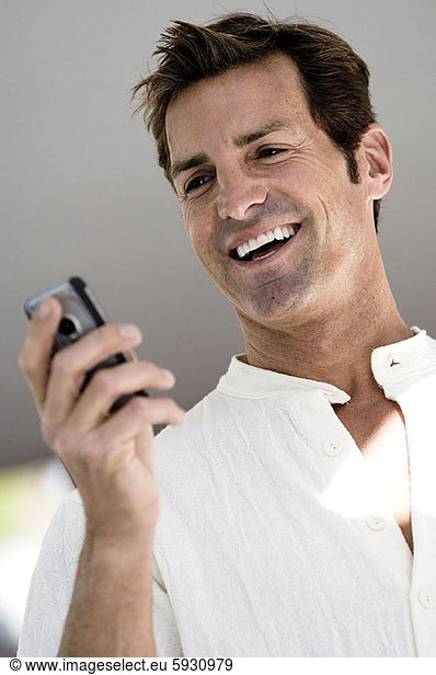 Close-up of a mid adult man looking at a mobile phone. Close-up of a mid adult man looking at a mobile phone