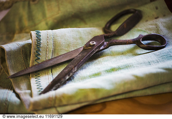 Close up of a pair of rusty scissors in a sailmaker's workshop.