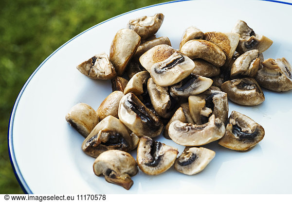 Close up of a plate of fried mushrooms.