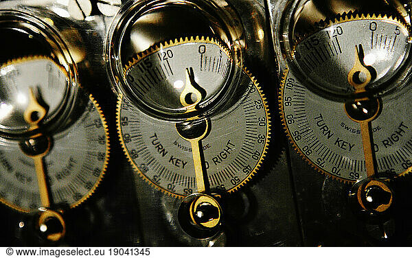 Close-up of a row of old circular analog meters.