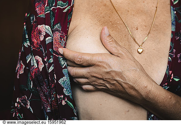 Close-up of a senior woman touching her breast