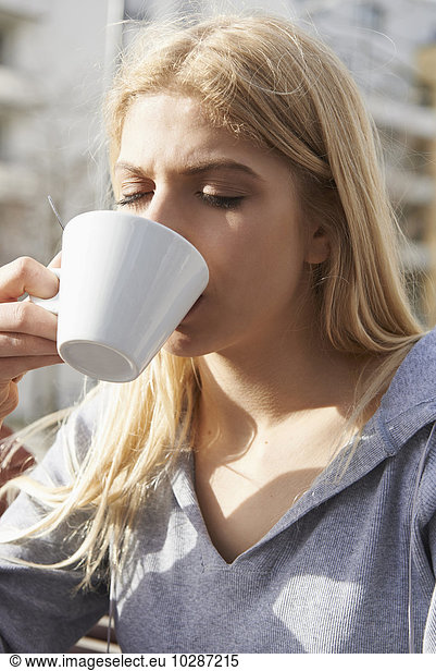 Close-up of a teenage girl drinking coffee  Munich  Bavaria  Germany
